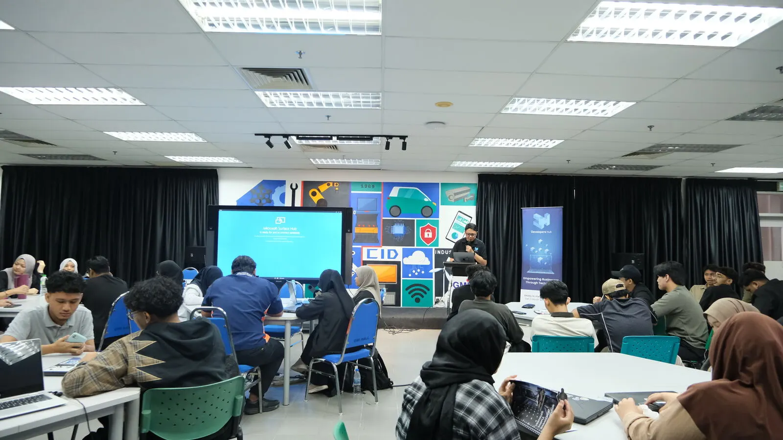 Participants working through the hands-on steps on their own laptops
